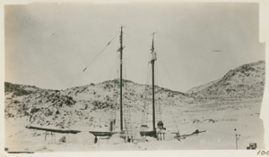 Image of The Bowdoin in winter quarters, early Spring.